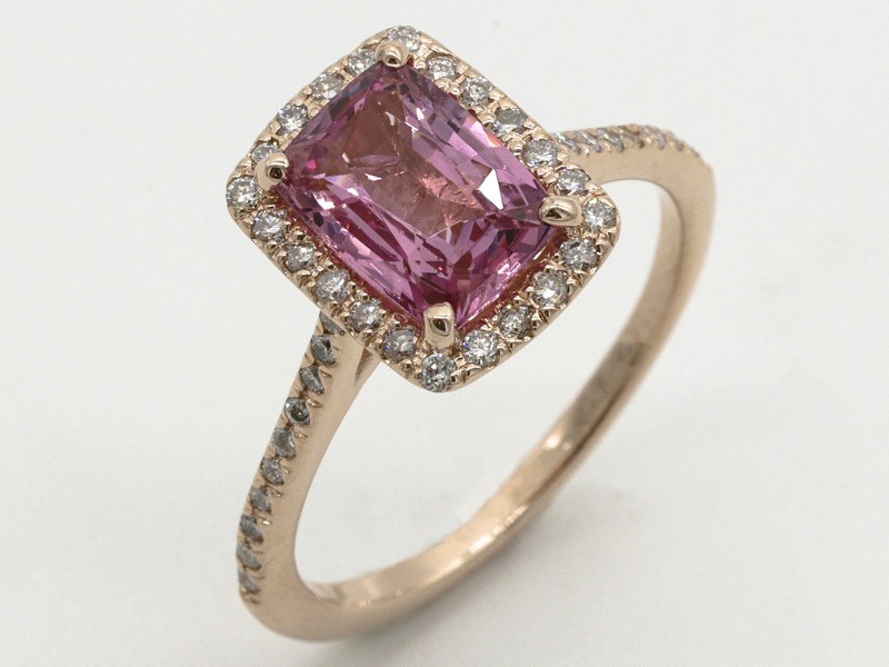 Pink sapphire and diamond halo ring after stone setting at our Greensboro bench
